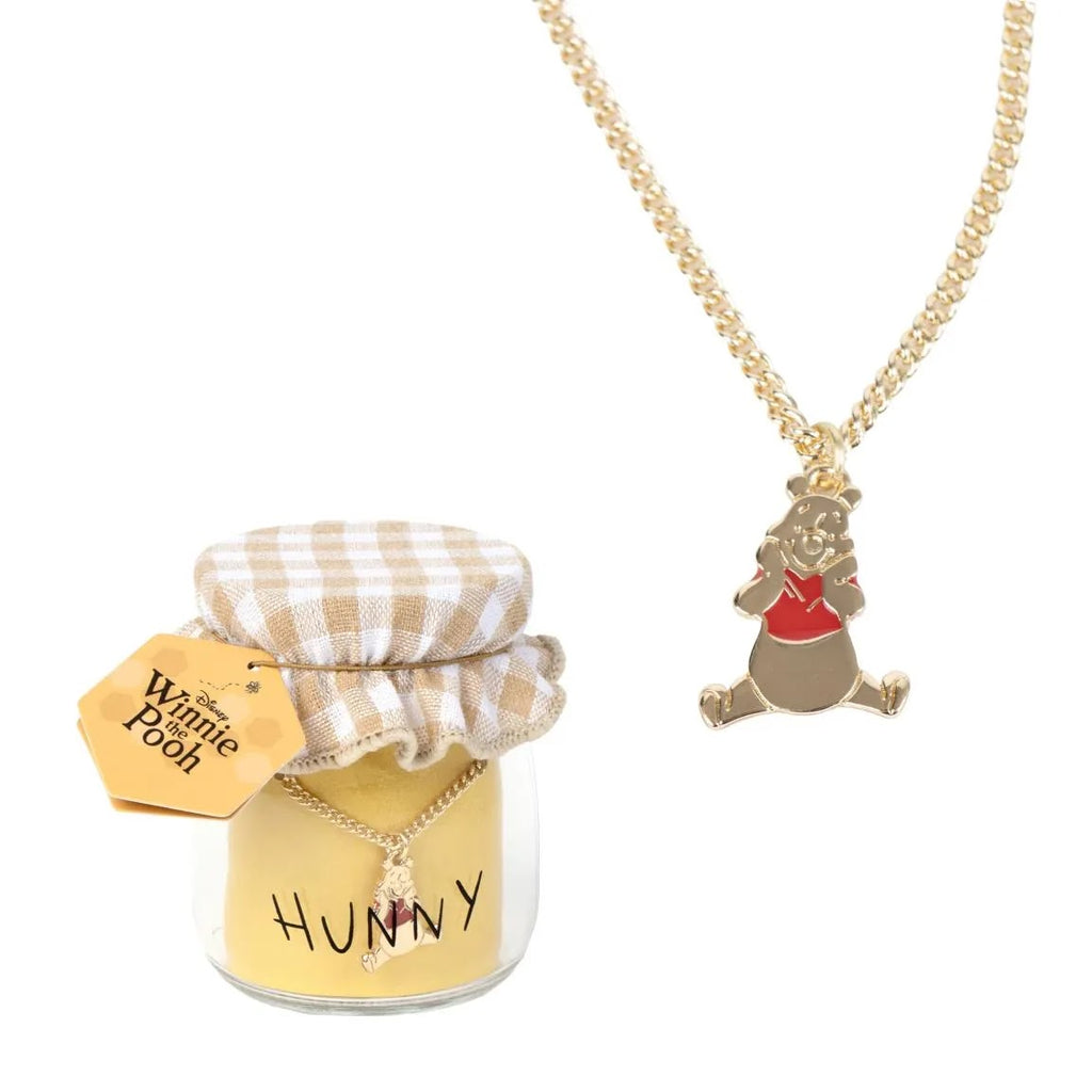 Disney Winnie the Pooh ketting goudkleurig met Pooh hanger naast HUNNY honingpotje