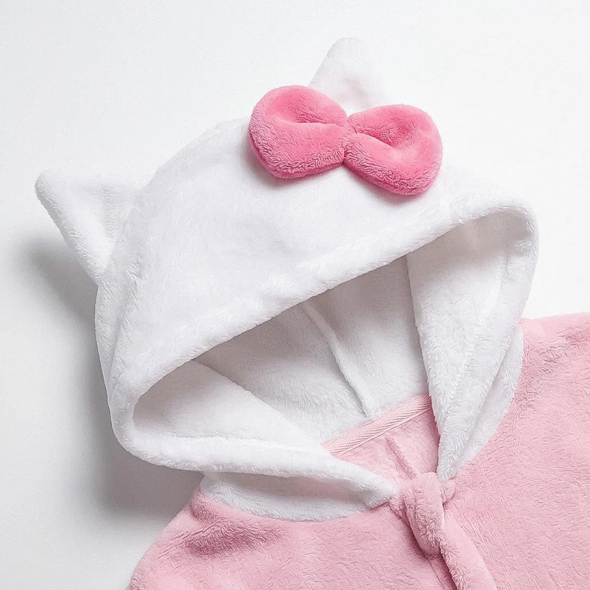 Detail witte capuchon met kattenoortje en roze strik